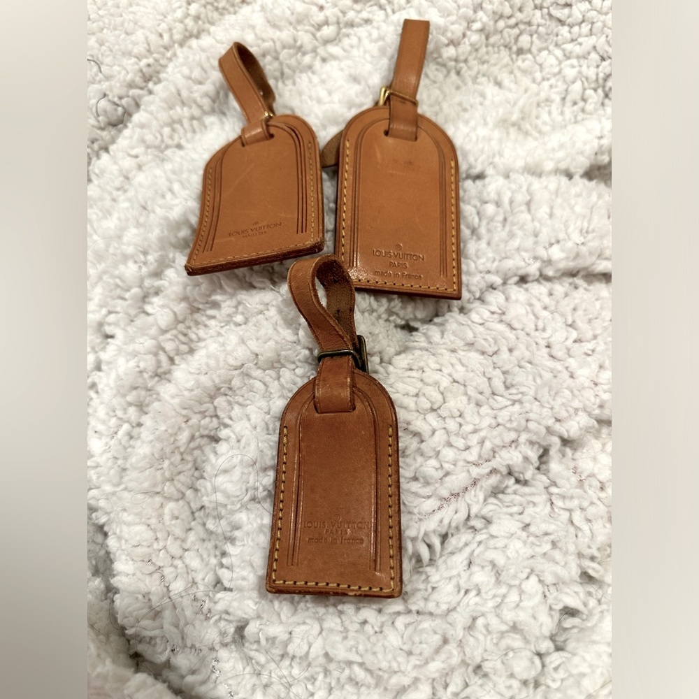Louis Vuitton luggage tags. Pick one only.